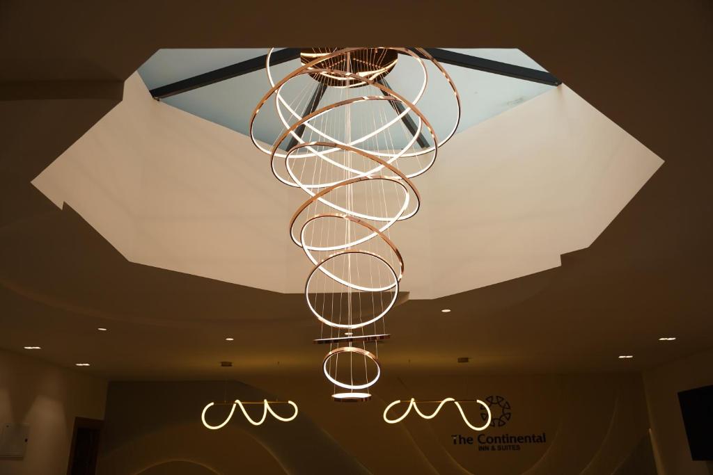 a chandelier hanging from the ceiling in a room at THE CONTINENTAL INN & SUITES in Mysore