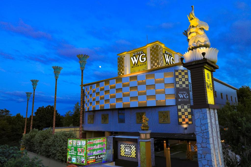 a building with a wwx sign on top of it at ホテルウォーターゲート香芝 in Kashiba