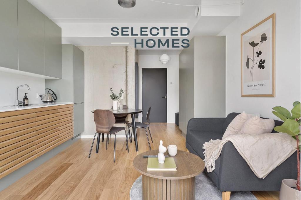 a living room with a couch and a table at Little luxury apartment in Aarhus