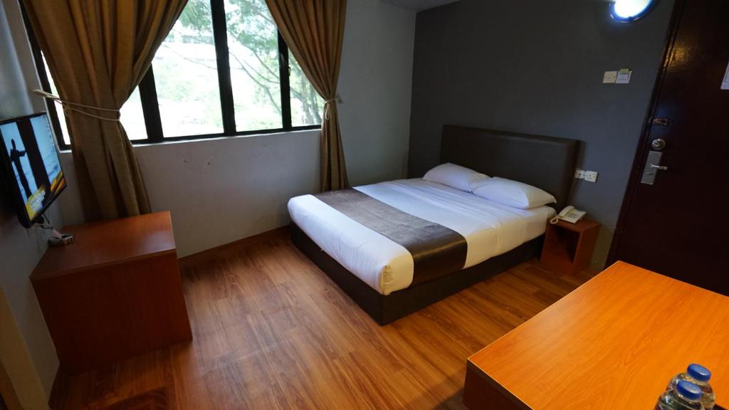 Postel nebo postele na pokoji v ubytování Zen Zeng Hotel