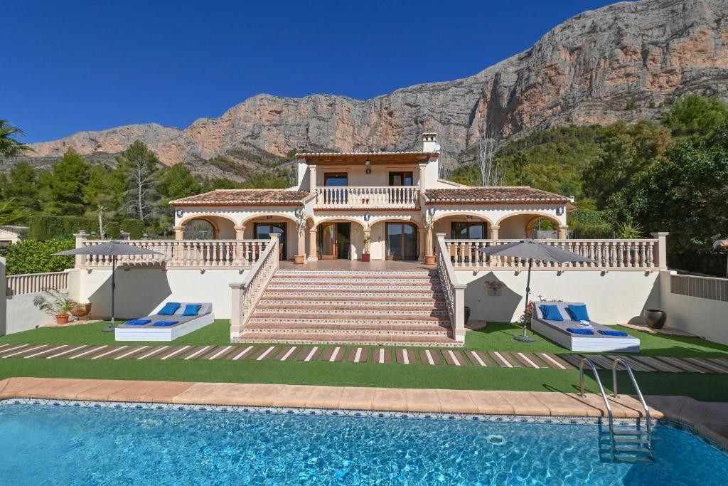 une maison avec une piscine en face d'une montagne dans l'établissement Altar, à Jávea