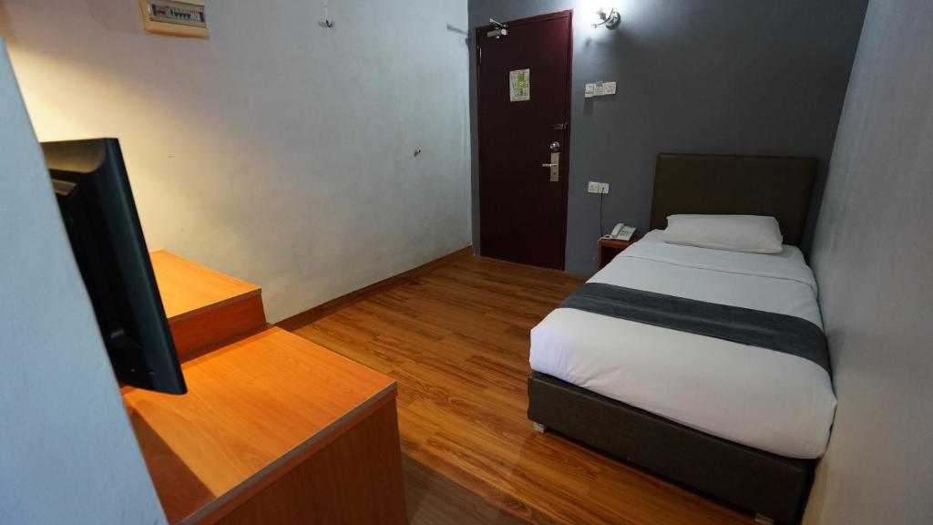Postel nebo postele na pokoji v ubytování Zen Zeng Hotel