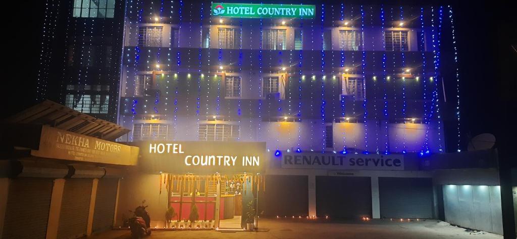 un edificio con luces azules encima en HOTEL COUNTRY INN, en Dimāpur