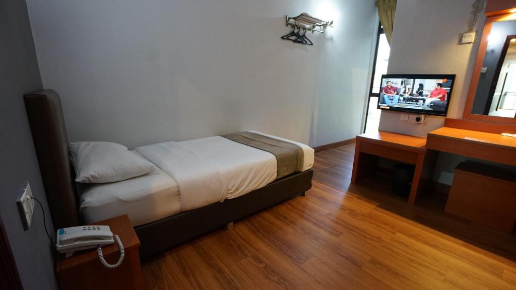 Postel nebo postele na pokoji v ubytování Zen Zeng Hotel