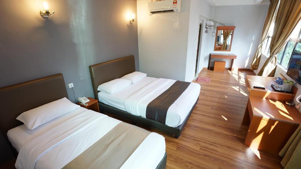 Postel nebo postele na pokoji v ubytování Zen Zeng Hotel