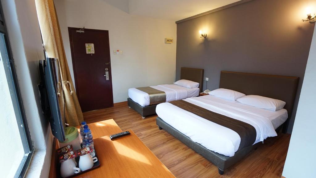 Postel nebo postele na pokoji v ubytování Zen Zeng Hotel