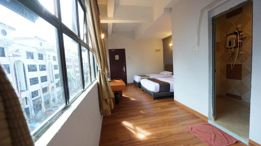 Postel nebo postele na pokoji v ubytování Zen Zeng Hotel