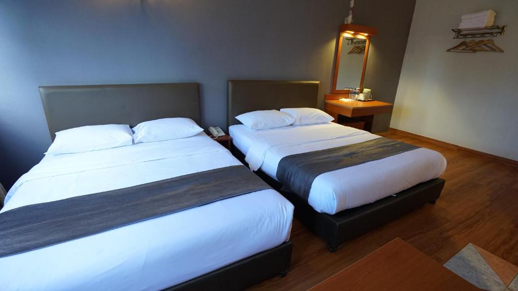 Postel nebo postele na pokoji v ubytování Zen Zeng Hotel