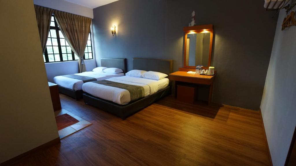 Postel nebo postele na pokoji v ubytování Zen Zeng Hotel