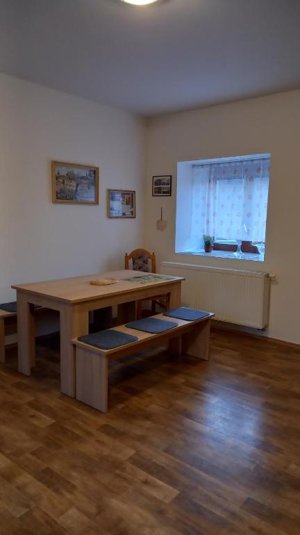 a large room with a wooden table and a window at Apartmán v Ladově kraji in Ondřejov