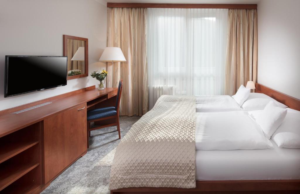 Postel nebo postele na pokoji v ubytování Pinia Hotel & Resort