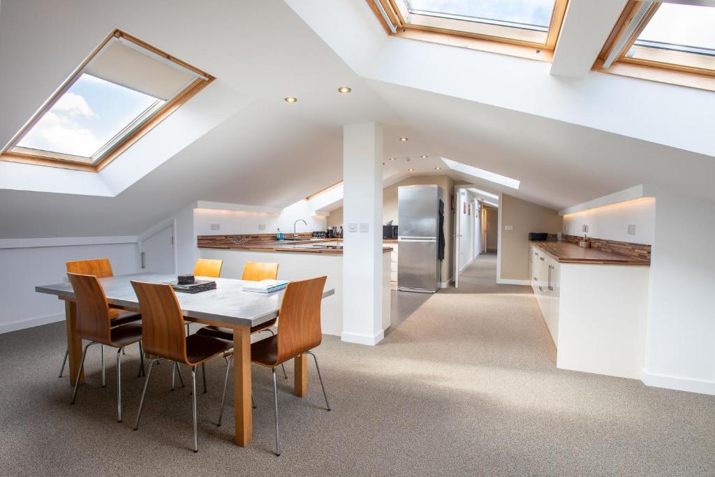 a kitchen and dining room with a table and chairs at Dunston Stables- Spectacular Countryside Setting in Newton Abbot