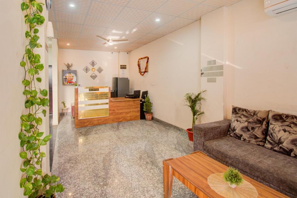 a living room with a couch and a table at Hotel Bhagwati Palace in Jaipur