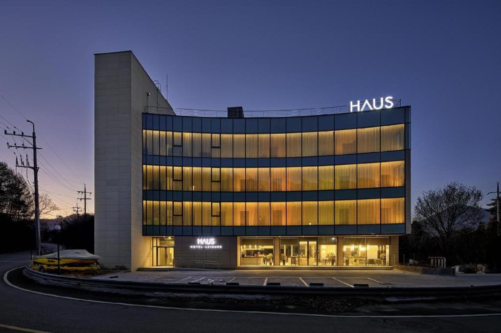 a large building with a sign on the side of it at Hotel Haus in Gapyeong