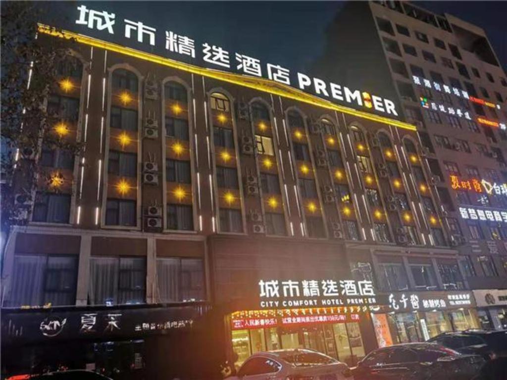 a building with a sign on the side of it at City Comfort Premier Hotel Bozhou Municipal Government Weiwu Square in Bozhou