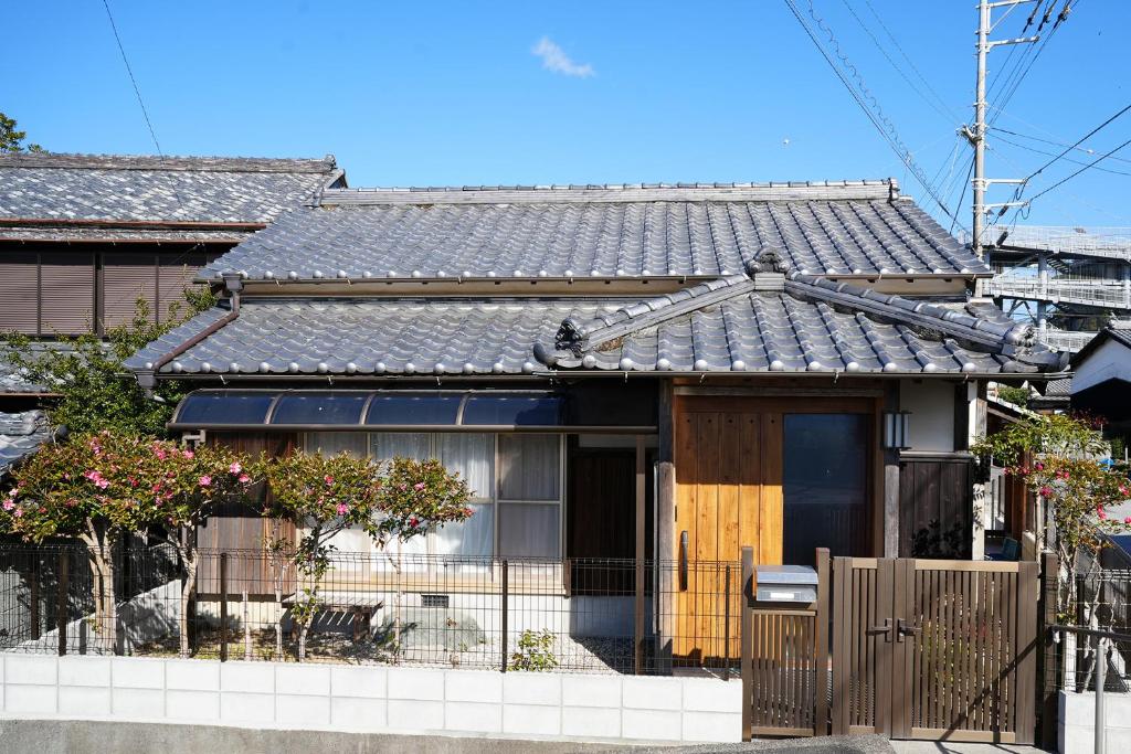 a house with a fence in front of it at 宿や晴 in Ioki