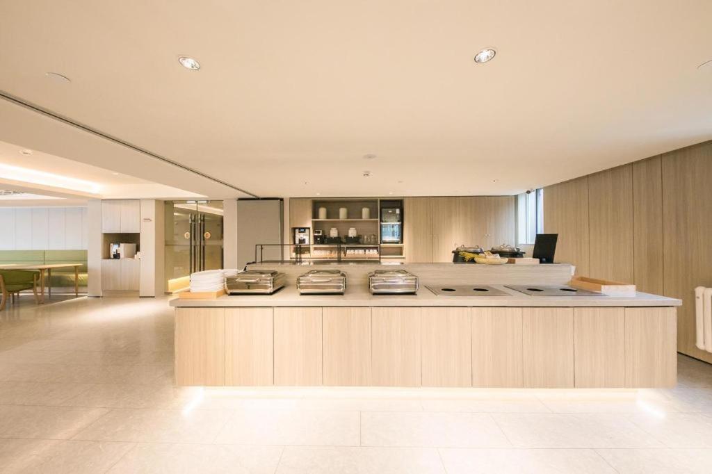 a large kitchen with a large island in a room at JI Hotel Beijing Dazhongsi in Beijing