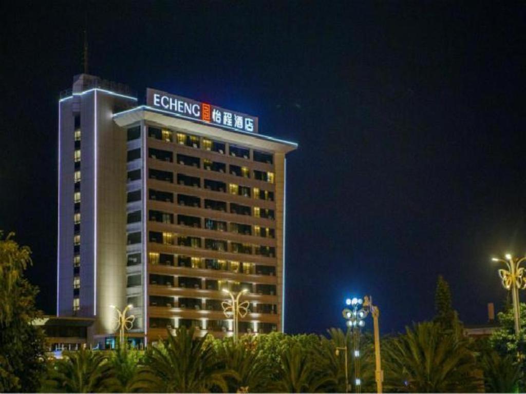 a building with a sign on top of it at night at E-Cheng Hotel Dali High-Speed Railway Station Erhai Lake in Dali