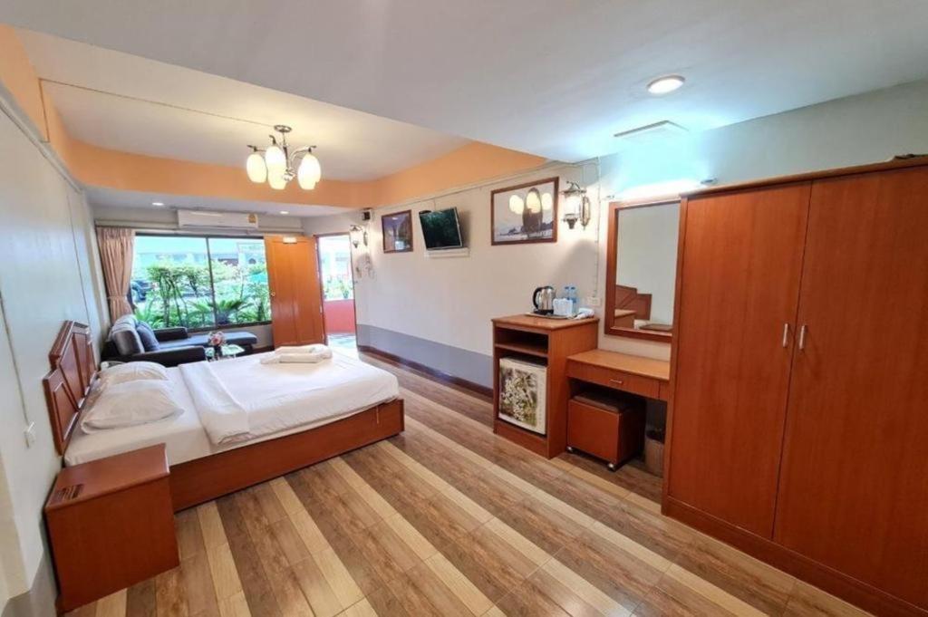 a bedroom with a bed and a sink and a mirror at Phu Nga Hotel in Natai Beach