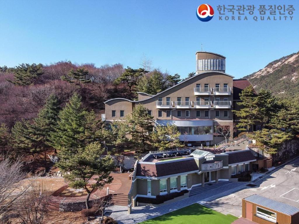 an aerial view of a building with a water tower at Hotel West of Canaan (Korea Quality) in Sangch'o