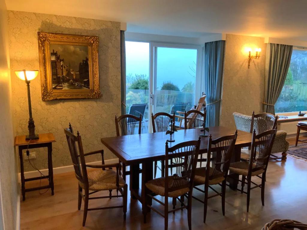 a dining room with a table and chairs at Pass the Keys Clifftop home mature gardens stunning sea views in Teignmouth