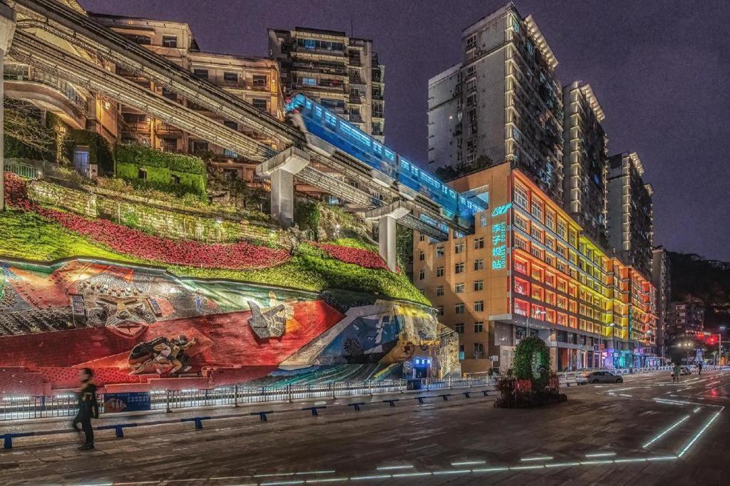 a building with a large mural on the side of it at Xiangsu Boang Hotel in Chongqing