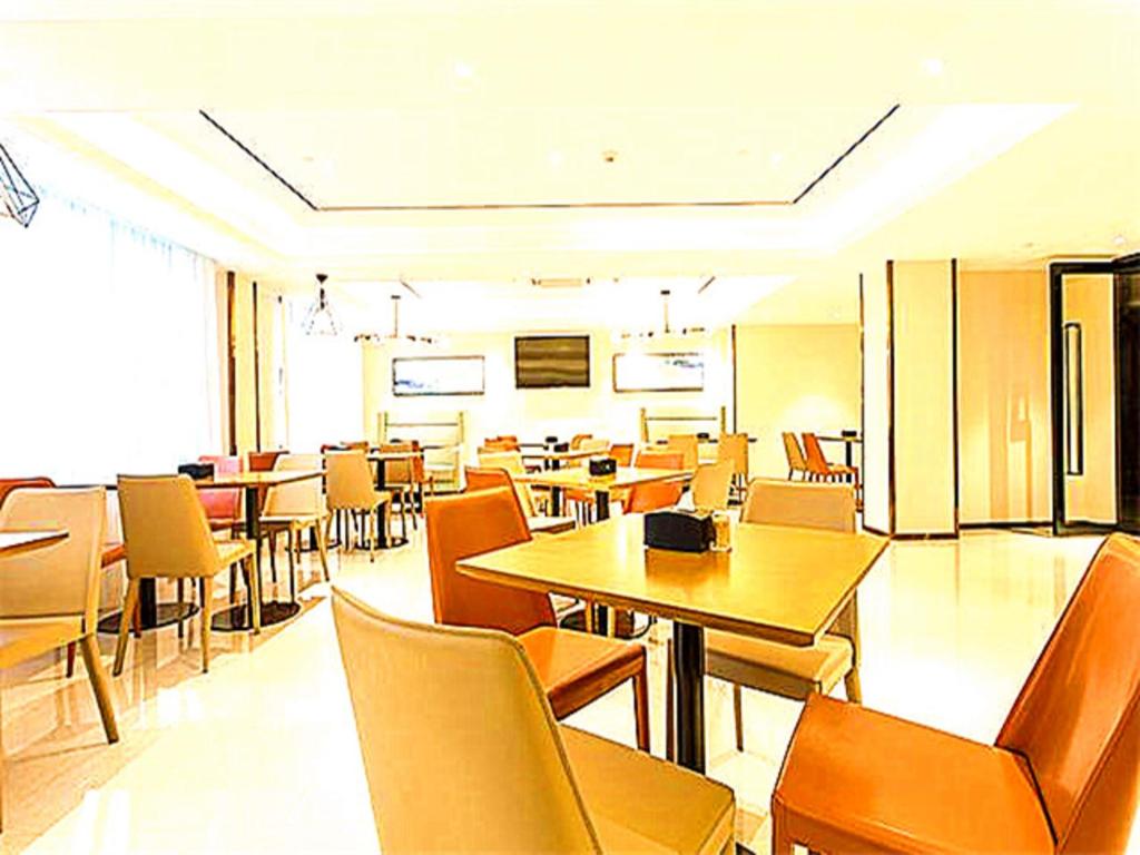 a dining room with tables and chairs and tablesktop at City Comfort Inn Qingyuan Longtang Light Rail Changlong in Qingyuan