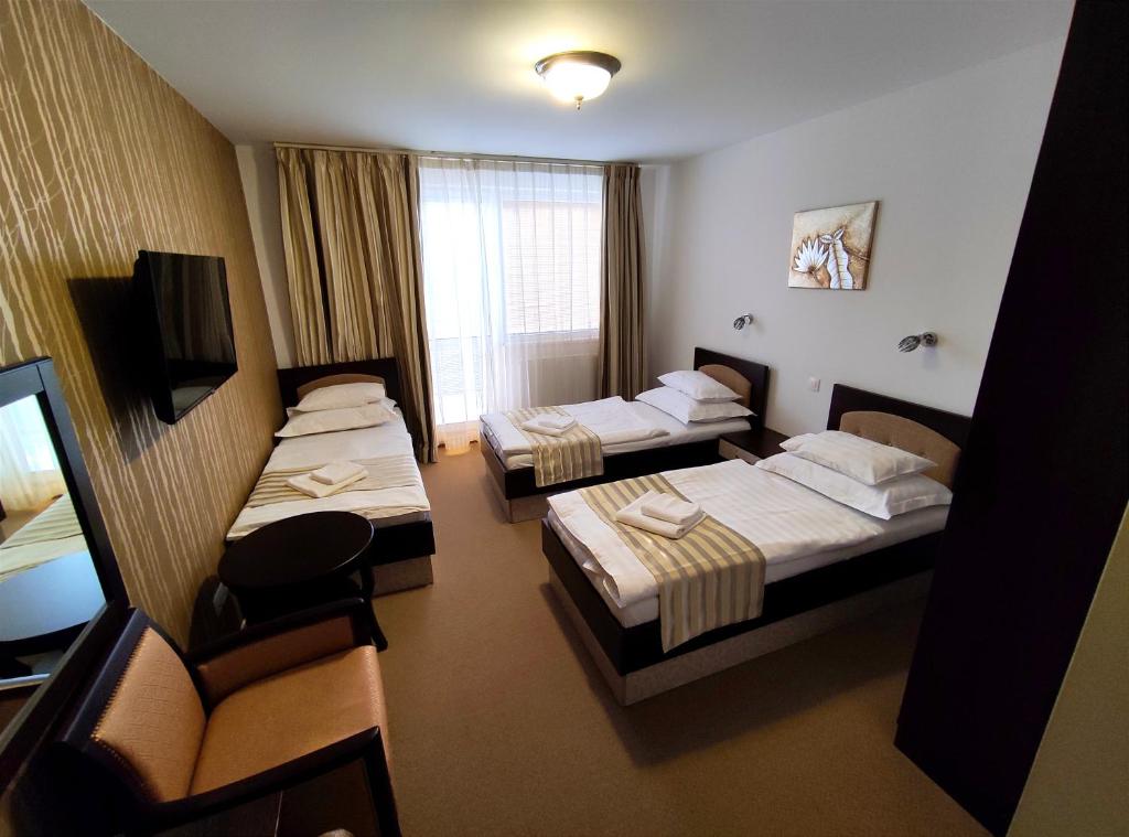 Postel nebo postele na pokoji v ubytování Hotel Sun