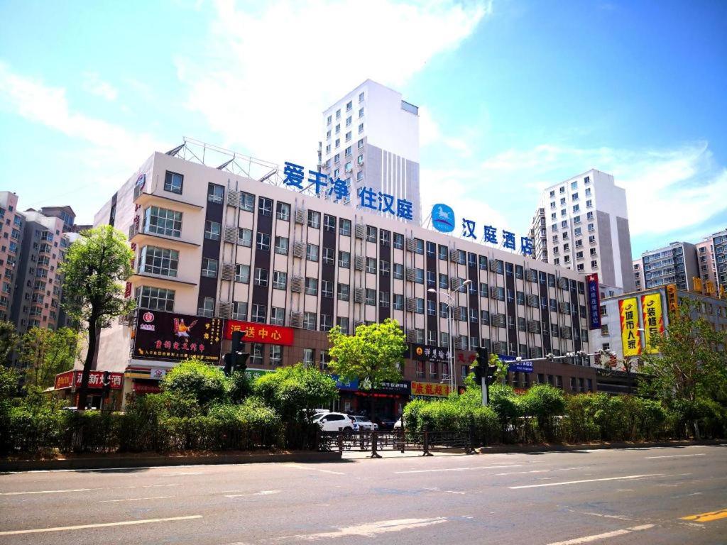 a large building in the middle of a city at Hanting Hotel Datong Xihuan Road in Datong