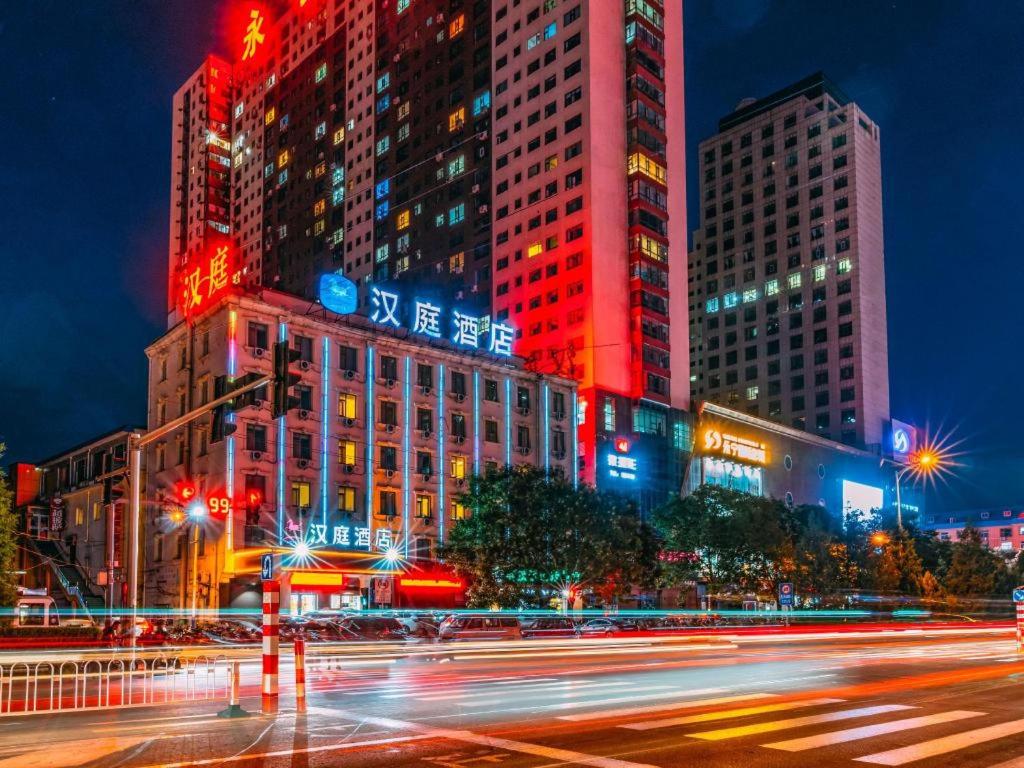 a city skyline with tall buildings at night at Hanting Hotel Lvliang Citizen Square in Luliang