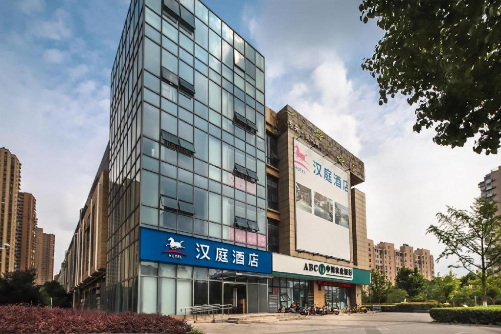 un grand bâtiment avec un panneau sur son côté dans l'établissement Hanting Hotel Nanjing Daishandong Laiao Nancheng, à Xishanqiao