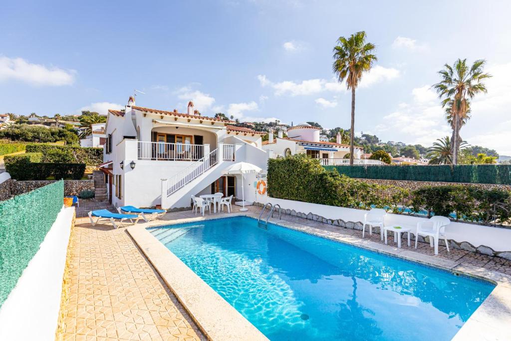 a villa with a swimming pool and a house at Villa Ponent in Son Bou
