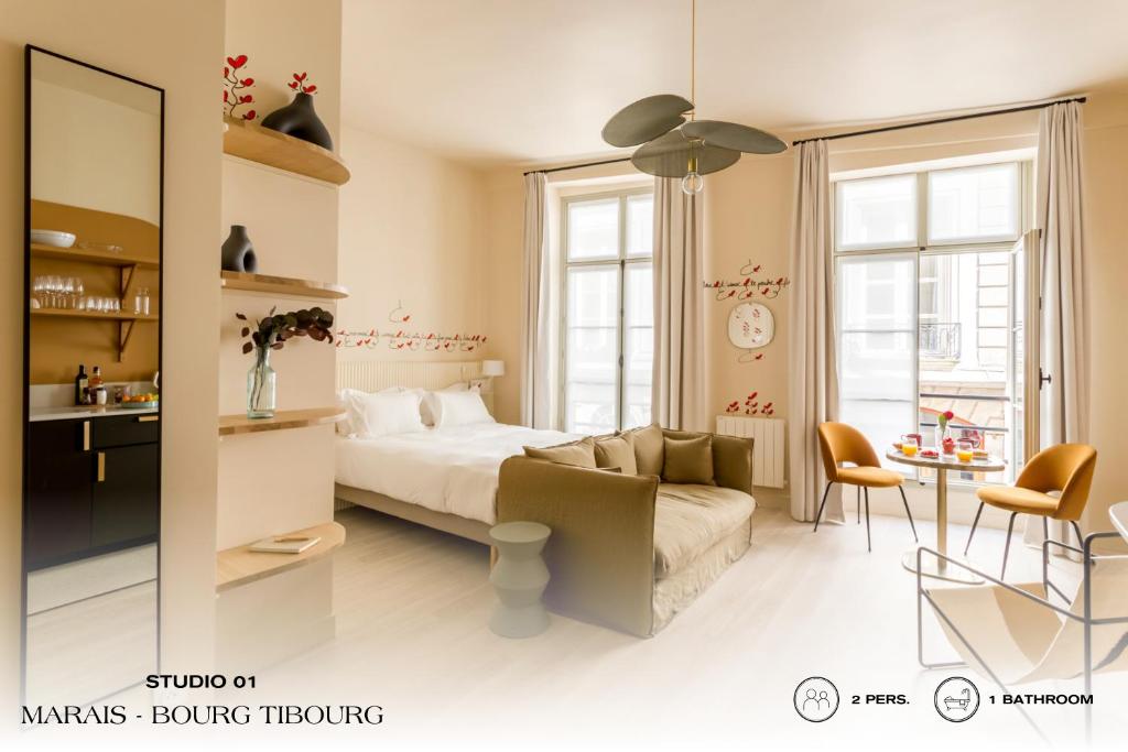 1 dormitorio con cama, sofá y mesa en Beauquartier - Marais, Bourg Tibourg, en París