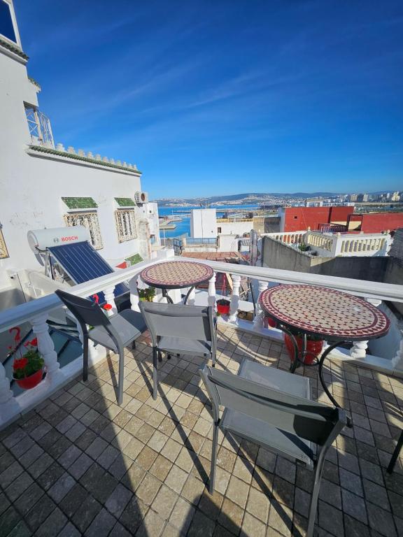 a patio with a table and chairs on a balcony at Dar Bargach in Tangier