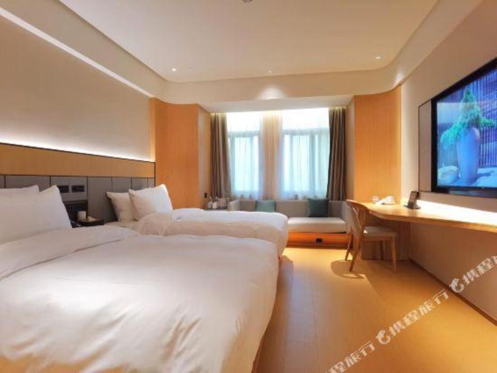 Giường trong phòng chung tại Ji Hotel Hefei Sipailou