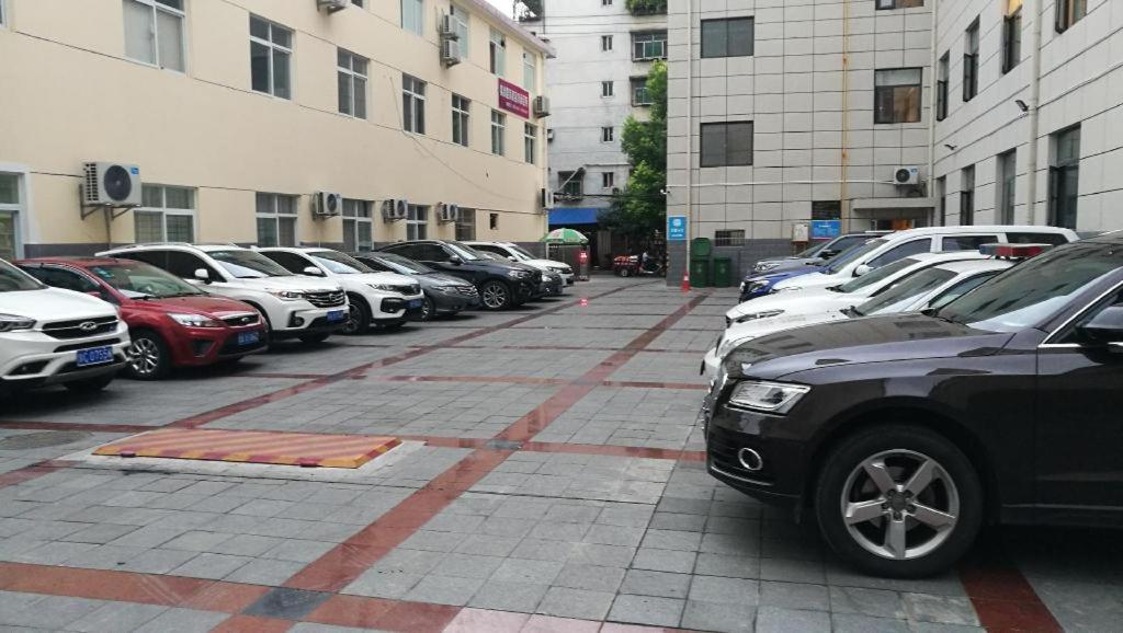a row of cars parked in a parking lot at Hanting Hotel Hanzhong Tianhan Avenue Railway Station in Hanzhong