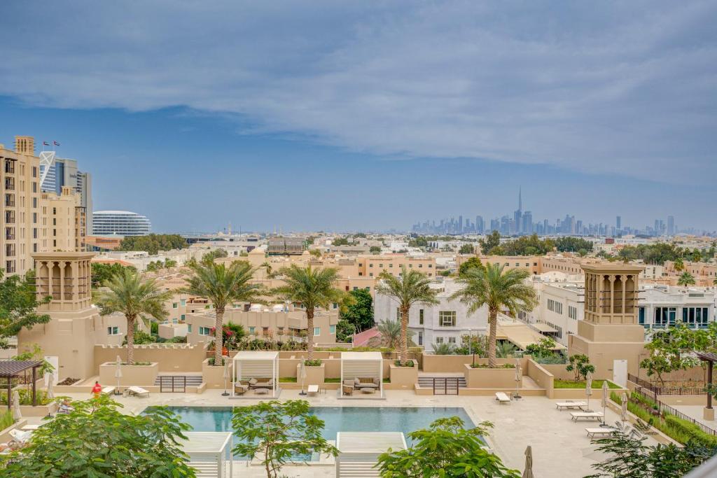 a view of a city with a pool and buildings at Trophy - Blissful Haven with Breathtaking View in Dubai