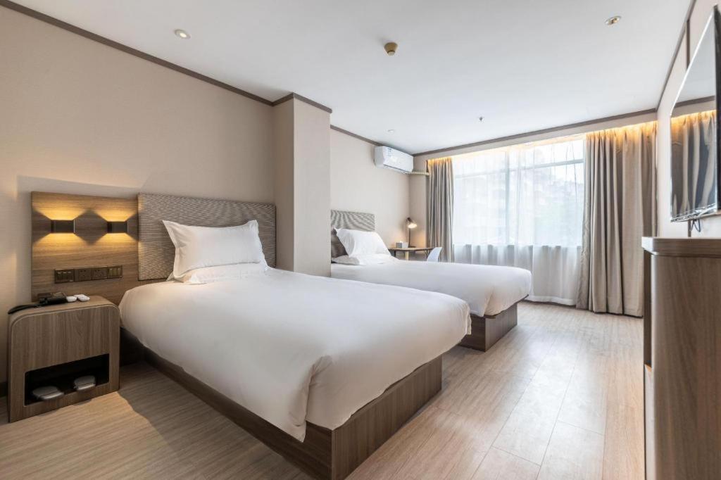 Krevet ili kreveti u jedinici u okviru objekta Hanting Hotel Xiamen Airport Chenggong Avenue
