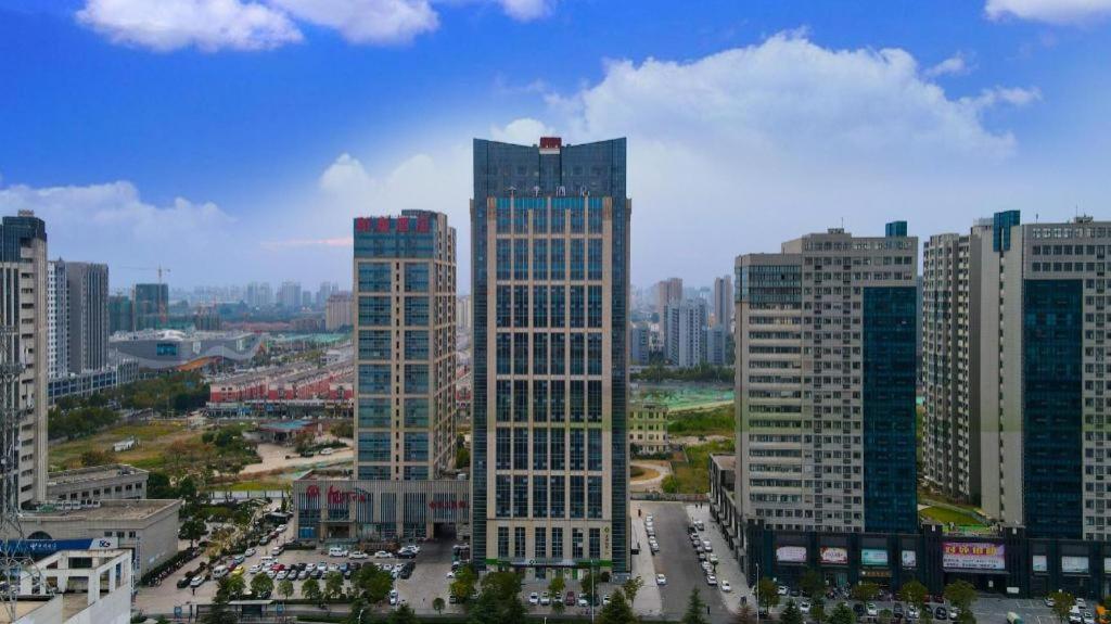 a group of tall buildings in a city at Ji Hotel Suqian Wanda Plaza in Suqian