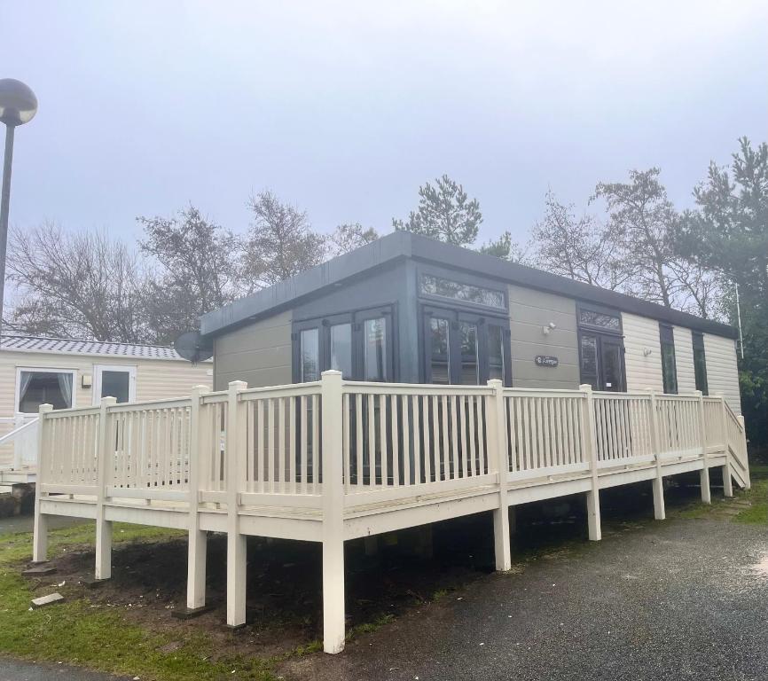 a house with a porch and a white fence at Blackpool caravans dog friendly in Blackpool