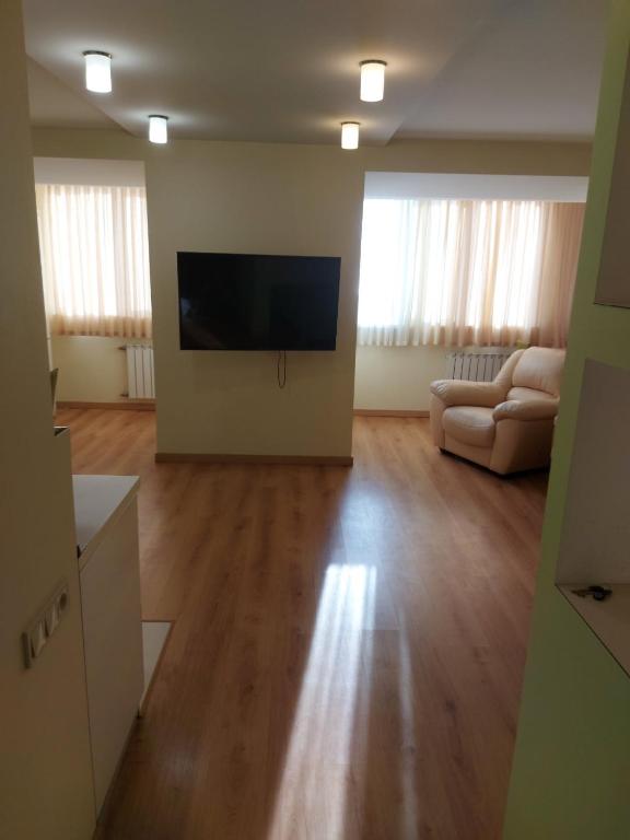 a living room with a flat screen tv and a couch at Слобожанский Новый мост 1 кв in Dnipro