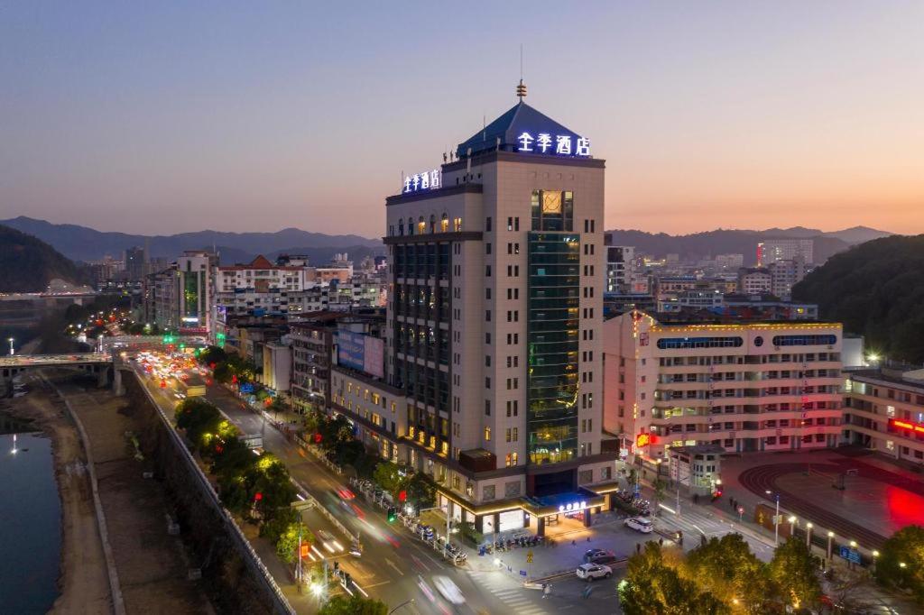 a tall building with lights on top of a city at Ji Hotel Nanping Jianyang District Government in Tancheng