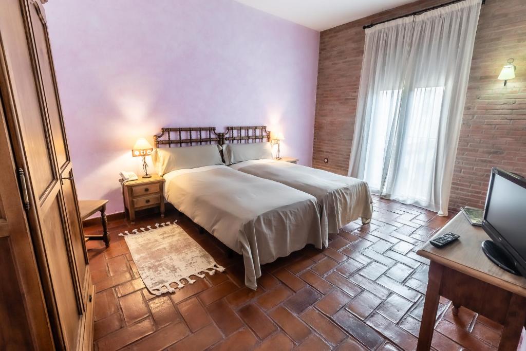 Posteľ alebo postele v izbe v ubytovaní Hotel Rural La Sinforosa