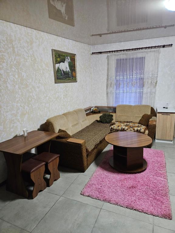 a living room with a couch and a table at Апартаменти в Кропивницькому in Kropyvnytskyi