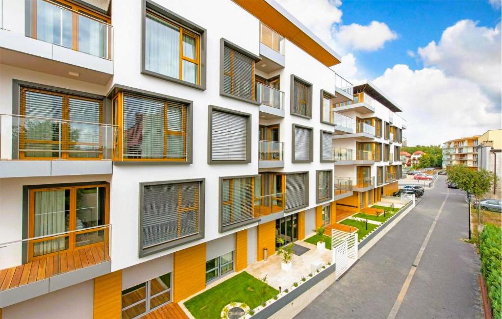 an apartment building with orange and white windows at 2 Bedroom Gorgeous Apartment In Hel in Hel