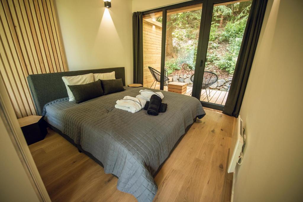 ein Schlafzimmer mit einem Bett mit Handtüchern darauf in der Unterkunft Fenyővölgy Luxus Pihenőház ***** Mátrakeresztes in Matrakeresztes