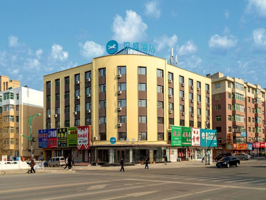 a large building with signs in front of a street at Hanting Hotel Tieling Changtu Railway Station in Changtu