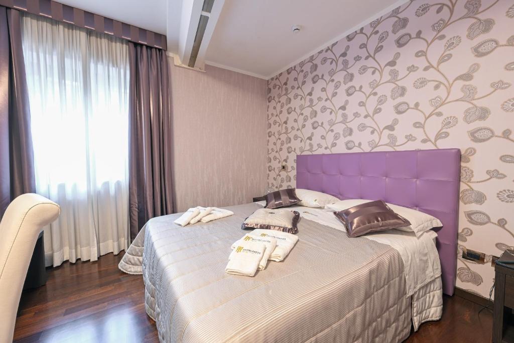 Postel nebo postele na pokoji v ubytování Hotel Mastrodattia