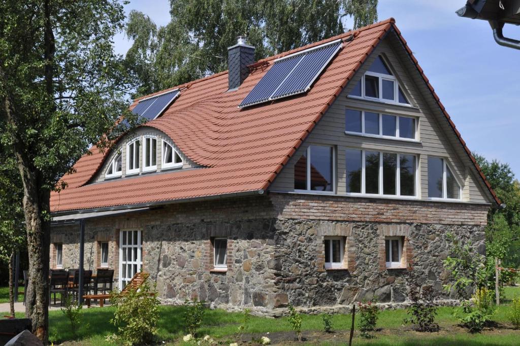 a house with solar panels on the roof at Hexenhaus in Rietz Neuendorf
