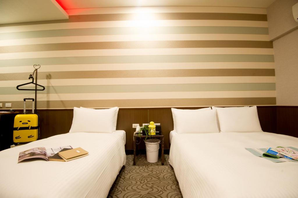 Postel nebo postele na pokoji v ubytování Moshamanla Hotel - Ximen